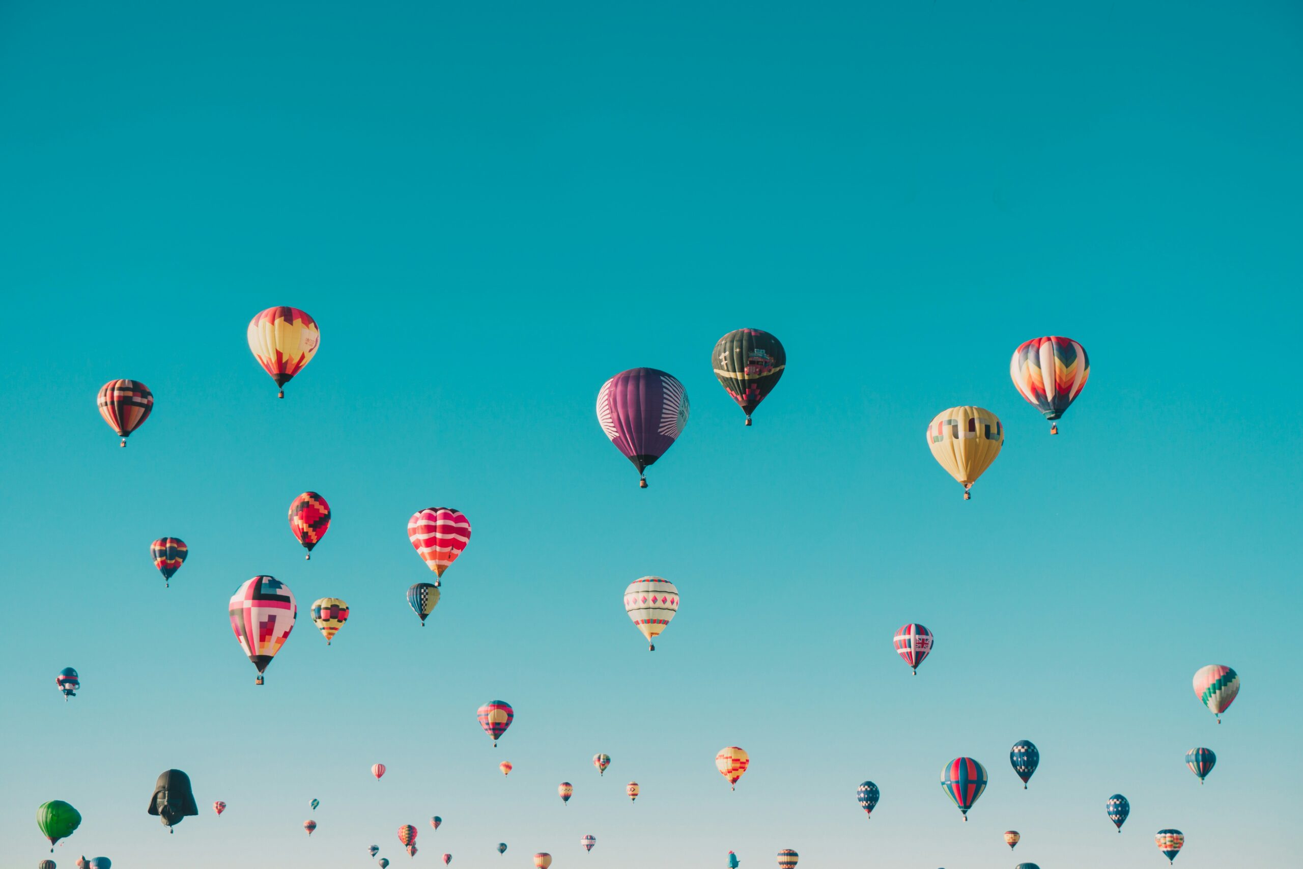 Hot-air balloons at sunrise symbolizing elevation, perspective, trust, and gentle progress in dreams.